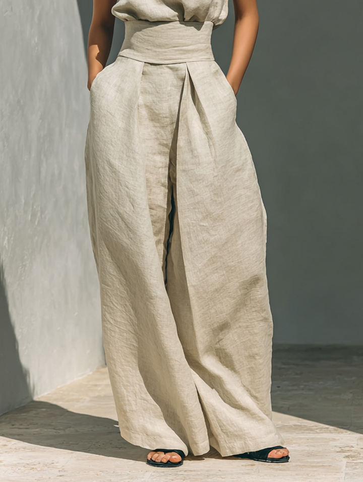 Minimalistiskt set för dam med ärmlös blus och byxor med vida ben
