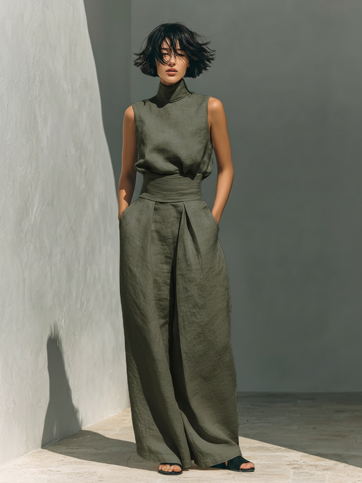 Minimalistiskt set för dam med ärmlös blus och byxor med vida ben